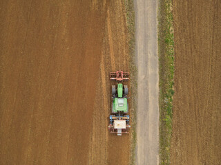 View from above of a tractor plowing the farm field