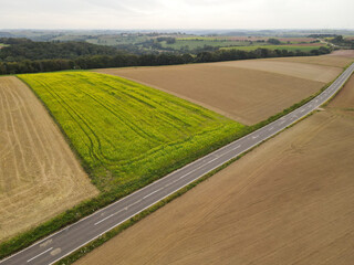 Aerial view of a road between farm fields in the countryside 
