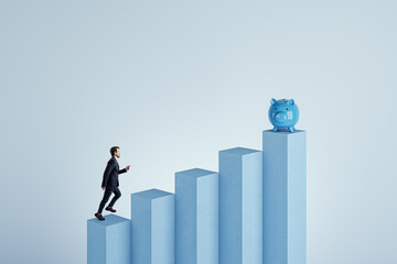 Side view of young businessman climbing blocks to piggy bank on blue background. Financial growth, investment and savings concept. Mock up place. - obrazy, fototapety, plakaty