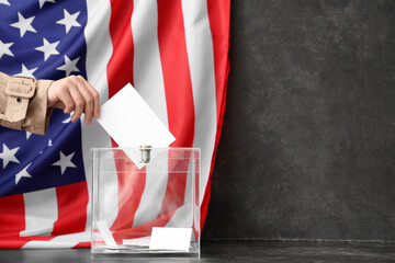 Voting woman near ballot box on table and flag of USA against black background