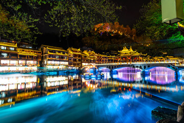 Laser show at Feng Huang Ancient Town (Phoenix Ancient Town) and tourist boats on Tuo Jiang River, The famous tourist destination at Hunan Province, China - 772836133