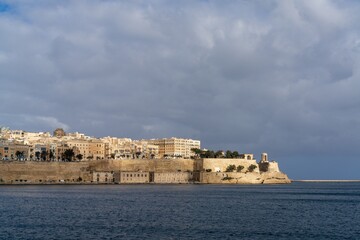 Fototapeta na wymiar view of downtown Valletta and St. Elmo's Fire under an overcast sky