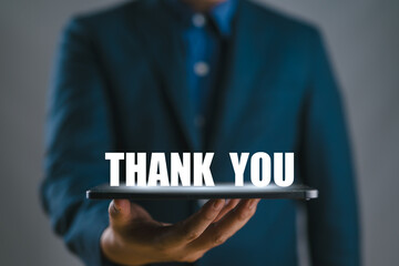 tablet shows the message thank you on a display screen. concept of thank you business,...