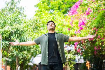 Freedom concept. Free Indian man with open arms on sunset admire nature view