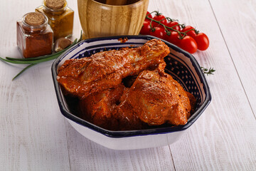 Raw turkey shoulder wing in Indian tandoori marinade