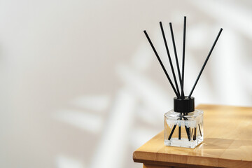 Modern Reed Diffuser on Wooden Table in Minimalist Interior During Daytime