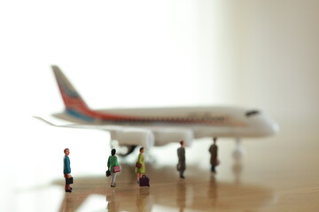 Miniature people waiting for a plane.