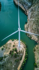 Aerial view of a wind turbine by the lake