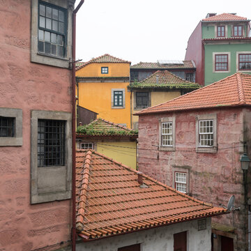 Details of the rooftops and the walls of the buildings in the Ribeira district of Porto, in Portugal. The area of the city is very old and the buildings are built very close to each other