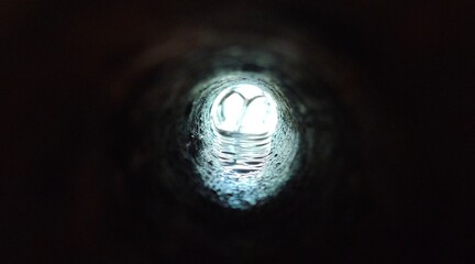 Used dark round and long sewage, sewer or drainage tunnel water pipe hole with industrial dirty...