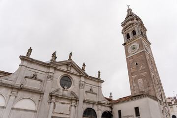 Fototapeta premium Venice church in a square with a large clock tower
