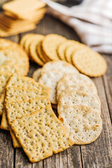 A stack of crackers neatly arranged on wooden tabletop.
