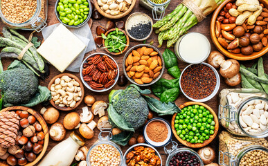 Vegan protein food background. Full set of plant based vegetarian food sources. Healthy eating, diet ingredients: legumes, beans, nuts, soy and almond milk, tofu, quinoa, vegetables, seeds and sprouts - obrazy, fototapety, plakaty