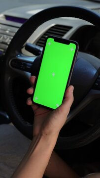 Person using a phone in car 