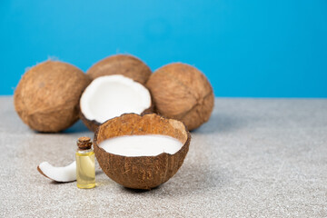 Coconut oil in a small glass bottle for skin and hair care, copy space for text