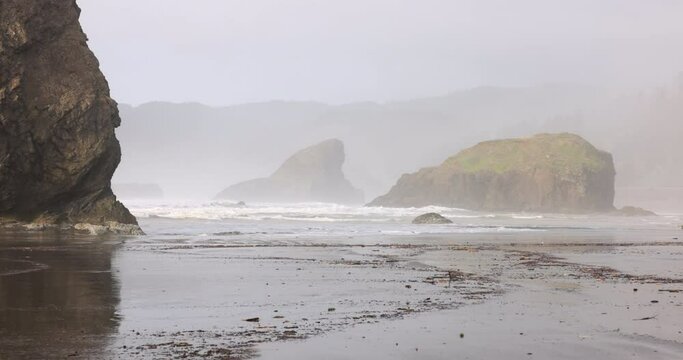 A foggy beach with rocks and a rocky shoreline in Oregon. Myers creek beach.