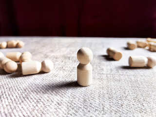 A lot of lying wooden toys and one standing one. There is an opportunity to win even when others give up. The strongest ones win. The loneliness of a leader in business