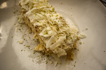 Holiday Napoleon cake or puff pastry cake with coconut chips and pistachio.On a glossy vintage...