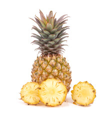 Pineapple with cut in half and slices isolated on white background.