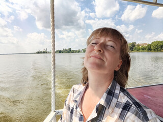 Fototapeta premium Happy Woman on a Sunny Day Outdoors on nature near water of lake or river in summer day