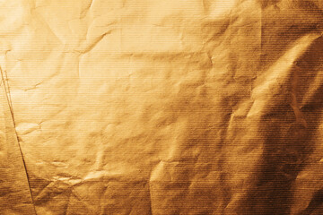Texture of gold colored wrapping paper surface