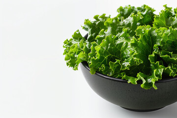 Close up bowl of green lettuce leaves in a black bowl on white background - obrazy, fototapety, plakaty