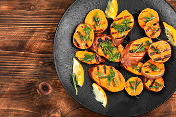 Grilled sweet potato on a plate. - 772923905