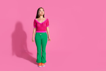 Full length photo of cheerful dreamy lady dressed knitted shirt walking loking empty space isolated pink color background