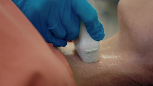 Patient Rests on Examination Table for Assessment of Thyroid by Physician. Ultrasound Examination Conducted on Female Patient at Medical Facility. Ultrasound. Health Concept