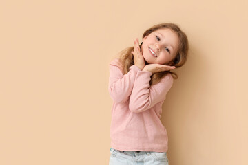 Happy little girl on beige background. Children's Day celebration