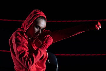 The athlete hits the fist straight ahead. Technical training before the fight in the ring.