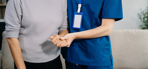 Female hands touching senior male hand Helping hands take care of the elderly concept in hospital