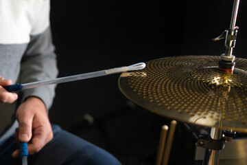 Drummer behind the drums in the studio, at a concert. Professional drum kit in close-up.
