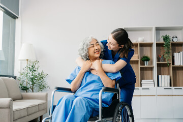 Fototapeta na wymiar Nurse helping elderly woman walk in the room, holding his hand, supporting. Treatment and rehabilitation after injury in assisted living facility, senior care .