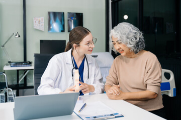 Portrait of female doctor explaining diagnosis to her patient. Doctor Meeting With Patient In Exam Room. A medical practitioner reassuring a patient