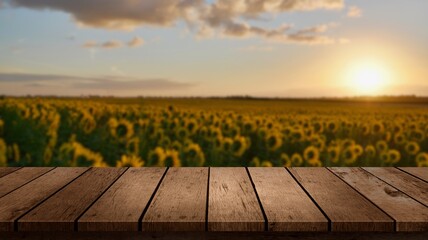 Wooden table with blurry sunflower landscape in the background