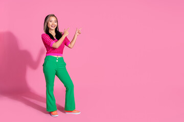 Full length photo of impressed funky lady dressed knitted shirt showing two fingers emtpy space isolated pink color background