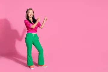 Foto op Aluminium Full length photo of impressed funky lady dressed knitted shirt showing two fingers emtpy space isolated pink color background © deagreez
