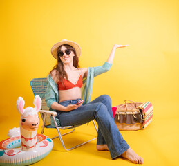 Smiling Young Woman with Sunglasses Enjoying Imaginary Sun on background Yellow