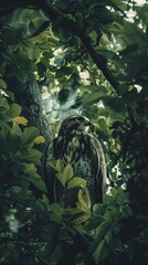 Fototapeta premium Eagle perched amidst green leaves