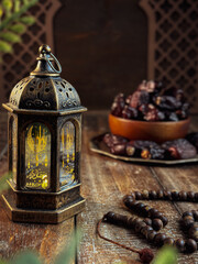 Fototapeta na wymiar lantern and dried dates during fasting month or Ramadhan muslim concept