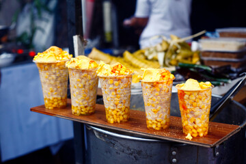 Freshly cooked sweet corn sold at a street food cart