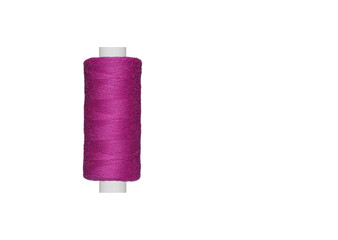 purple spool of sewing thread isolated on white background close up