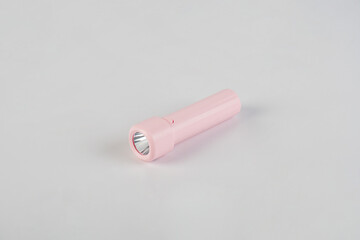 Pink electric LED torch flashlight isolated on a white background