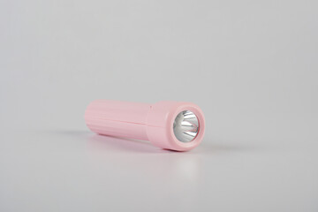 Pink electric LED torch flashlight isolated on a white background