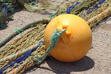 Orange float or buoy attached to old fishing nets at Sydney Fish Markets