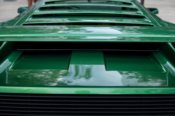 Close up of back part of carcase with radiator grill and spoiler on trunk. Design of external...