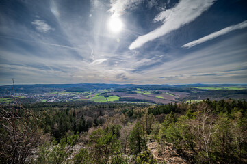 Beautiful view of landscape from mountain Plešivec in Czech Republic with cloudy sky, where the color is kind of orange because of Sahara sand in atmosphere showing us climatic changes