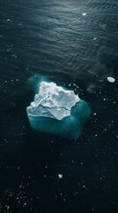 Fototapeta premium Aerial view of an iceberg in dark waters