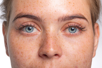 A close up of a person with blue eyes looking at the camera